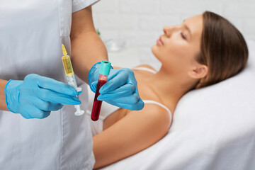 Cosmetologist does prp therapy on the face of a beautiful woman in a beauty salon. Cosmetology...