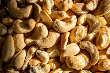 A close-up of roasted cashew nuts under natural light.