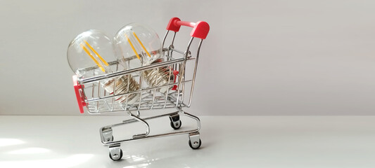 Shopping cart displaying light bulbs minimalist studio product photography modern aesthetic eye-level perspective