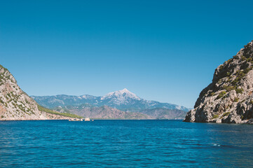 Breathtaking coastal landscape with turquoise waters and pine-covered mountains