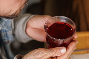 Close-up of a man's hands with a cup of hot tea.
