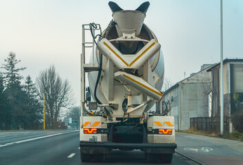 a concrete mixer car driving through the city street
