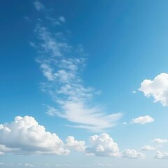Fototapeta premium Thin wisps of cloud drift lazily across a brilliant blue expanse, white clouds, wispy texture