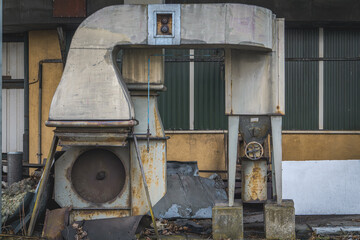 heating network, heat network, pre-insulated pipes, heat supply pipeline covered with bushes going up. old abandoned boiler room of closed production plants. rusty, damaged pipes. valves. industrial a