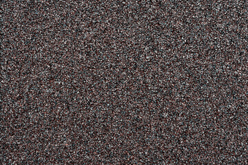 Small black stones texture and pattern, close-up photo suitable for background or design backdrop