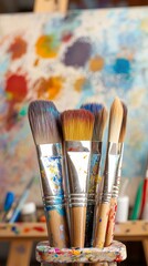 Fototapeta premium professional paintbrushes standing in a cup in an artist’s creative workspace