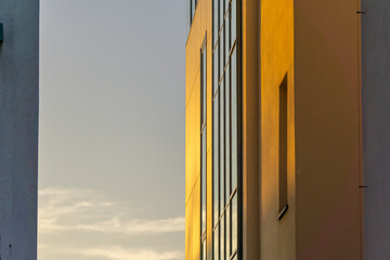 interesting modern urban architecture, modern construction and engineering. glass building with a view of the sky. sunlight falling on the windows and facade.