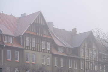 interesting old tenement house in the city center in the morning winter fog.