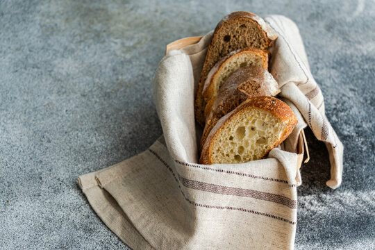 Close-up of Freshly sliced  brown and white sourdough bread in a bread basket