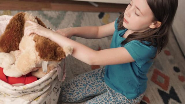 Chilchild, casual, caucasian, chore, chores, clean, clean up, cute, daughter, day, duty, education, toy, apartment, at home, bage, basket, beautifud cleans up her toys. Little girl tydies up her room.