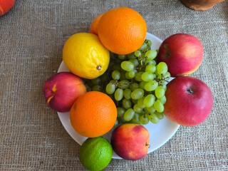 Assorted fruits and vegetables on a white plate. high-quality photo