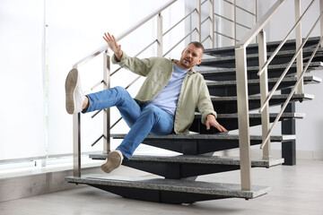 Man falling on stairs in building. Dangerous accident