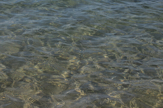 Summer vacation wavy, calm, deep blue sky, mountains, thin white clouds not visible, clear weather. boat, dinghy, rowboat far away. yellow shiny brown sea sand on shore beach. Balıkesir, Sarimsakli