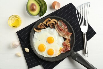 Tasty fried eggs with bacon and mushrooms served on white wooden table, flat lay