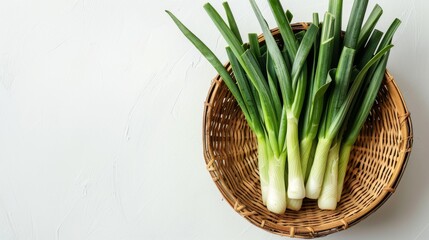fresh leek neatly arranged in a basket on a white background