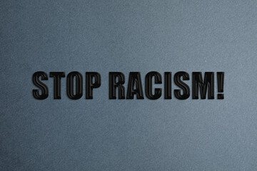 Stop Racism! Black text on grey background