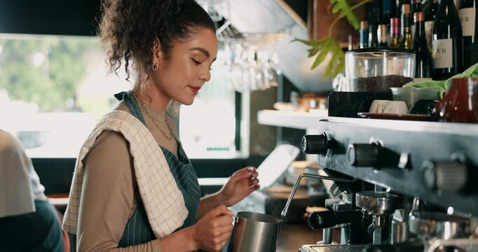 Milk, latte and waitress with woman in coffee shop for machine, cappuccino drink or cafeteria. Restaurant, espresso and barista with person and steam frother in cafe for mocha blend and brewing