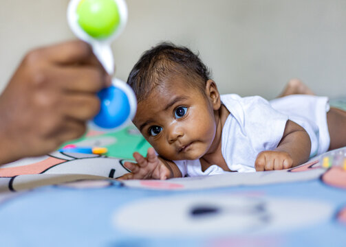 A little girl doing tummy time, a little girl. Newborn premature baby. Tummy time is fun time. African baby, African girl, black baby, Brazilian baby. Rio de Janeiro, Brazil.