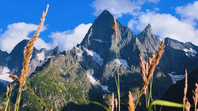 Teberdinsky Nature Reserve. View of Kosygin's glade in the Gonachkhir gorge and the top of Dombai-Ulgen mountain near Lake Tumanly-Kel on a sunny summer day. Panoramic landscape. Resort. 4K