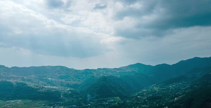 Time lapse showcasing breathtaking rural landscape of mountain village in China with dramatic weather changes