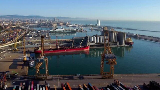 Barcelona, Spain - 3 February 2025: Aerial view of shipping containers and cargo ships in the sea port. Concept of sea and maritime trade and trade war due to tariffs. Commercial hub