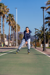 Obraz premium Senior woman enjoying roller skating on a sunny day, promoting healthy lifestyle and active aging