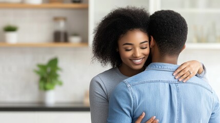 Fototapeta premium Loving Embrace in a Modern Kitchen - A joyful couple shares a loving moment in a modern kitchen, radiating warmth and happiness in their relationship.