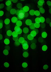 Obraz premium Abstract blurred bokeh background bright green lights on a black background bokeh green bokeh green abstract background light bright blur pattern