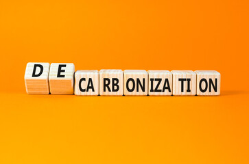 Decarbonization or carbonization symbol. Concept words Decarbonization or Carbonization on wooden blocks. Beautiful orange background. Business decarbonization or carbonization concept. Copy space.