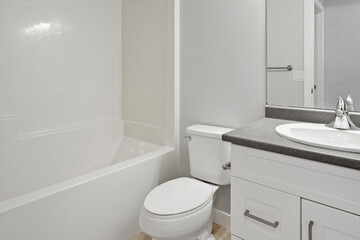 A bathroom with a white toilet and sink