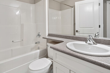 A bathroom with a white toilet and sink