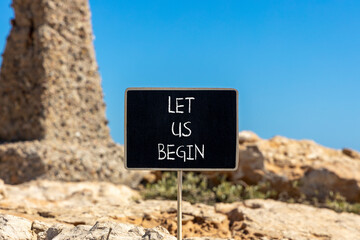 Let us begin symbol. Concept words Let us begin on beautiful black yellow blackboard. Beautiful...
