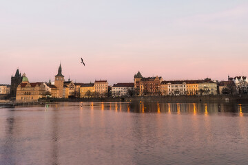 Sunset colors in Prague Historical Gothic Medieval castle, St. Vitus Cathedral, Charles Bridge and river Vltava boat cruise, astronomical clock, Unesco city tourism, golden hour and water reflection