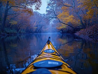 Fototapeta premium Lone paddler enjoys the autumn beauty of a river. A tranquil scene with vibrant fall colors and clear water.