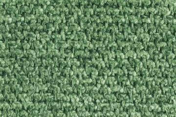 Texture of green jacquard fabric, close up of rough weave macro. Material for home textile, upholstery and curtain decor, garment. Background, wallpaper, backdrop.