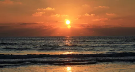 Printed kitchen splashbacks Dramatic sunset on the beach with 3 suns reflected