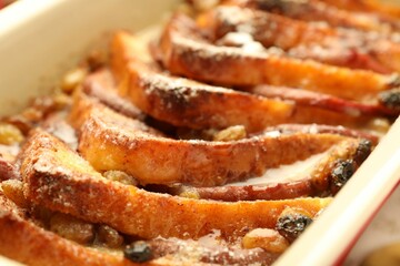 Freshly baked bread pudding in baking dish, closeup