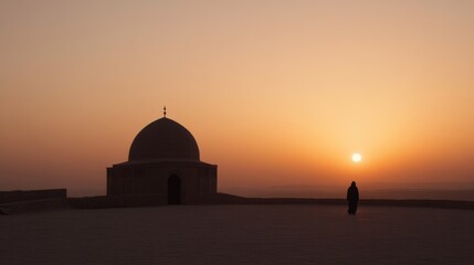 Obraz premium Sunrise at a mosque, silhouette of a person, desert landscape. Possible use Travel photography, religious imagery
