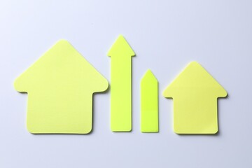 Yellow paper arrows on white background, flat lay