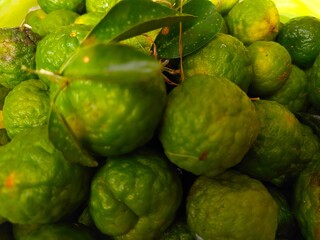 Kaffir lime (Citrus hystrix). This citrus fruit has a rough, wrinkled, green skin and is often used in Southeast Asian cuisine for its distinctive aroma and flavor.