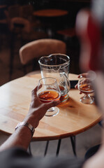hand taking a glass of beer in a bar