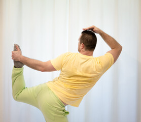 Male choreography in motion in the studio. Young man dancing in a dance studio