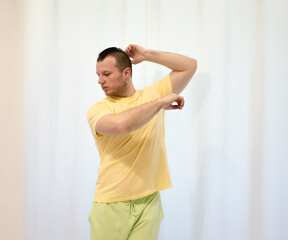 Male choreography in motion in the studio. Young man dancing in a dance studio