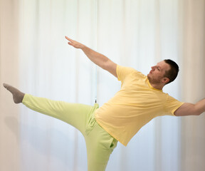 Male choreography in motion in the studio. Young man dancing in a dance studio