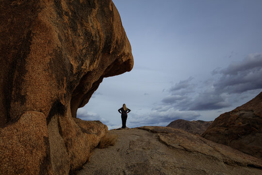 Woman Hiker Standing Among Rock Formations in Alabama Hills, California. 