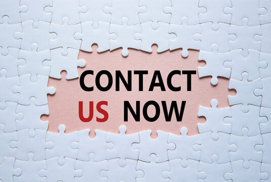 Contact us now symbol. White puzzle with words Contact us now. Beautiful pink background. Business and Contact us now concept. Copy space.