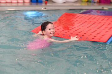 Young girl enjoying therapeutic swimming class