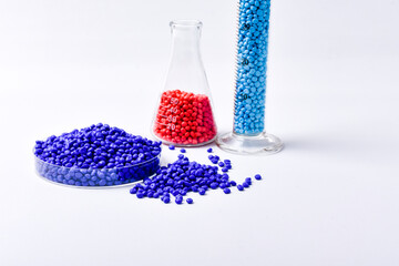Blue and soft pink masterbatch granules on white background, color pigment carrier polymer in...