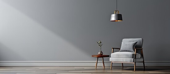 Gray interior featuring armchair, side table, hanging lamp, and empty wall. Modern and minimalist style.