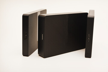Obraz premium Hard drives on a white background. Modern data storage devices with USB wires.